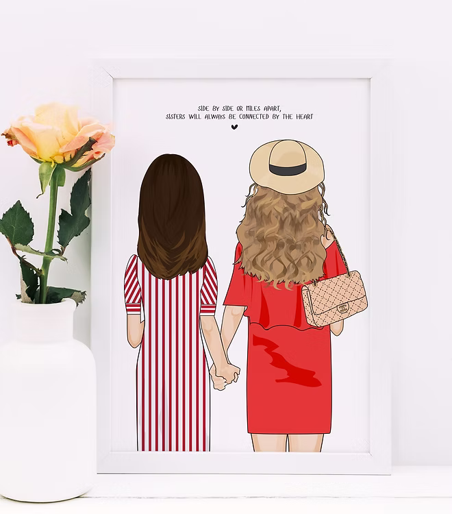 Sisters illustration print in white frame, holding hands, with a rose in a vase beside it
