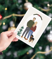 Hand holding custom illustrated family Christmas card with couple and dog, CostanzaToniniDesign