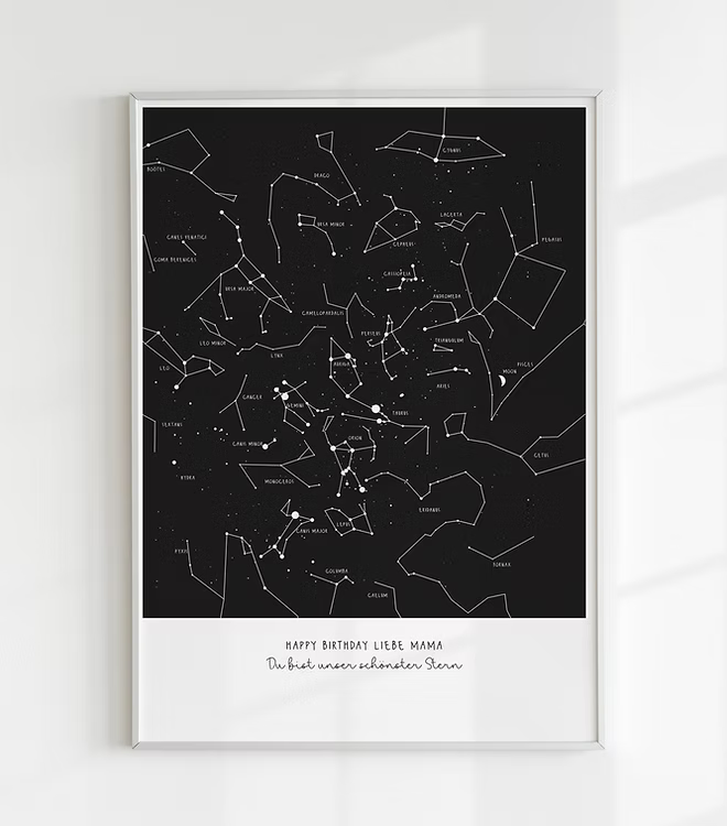 A personalized, hand-drawn star map print. The print features a detailed constellation map on a black background, showing the stars exactly as they appeared on a specific date and location. This is an ideal personalized anniversary gift, unique wedding present, or romantic engagement keepsake for home wall art.