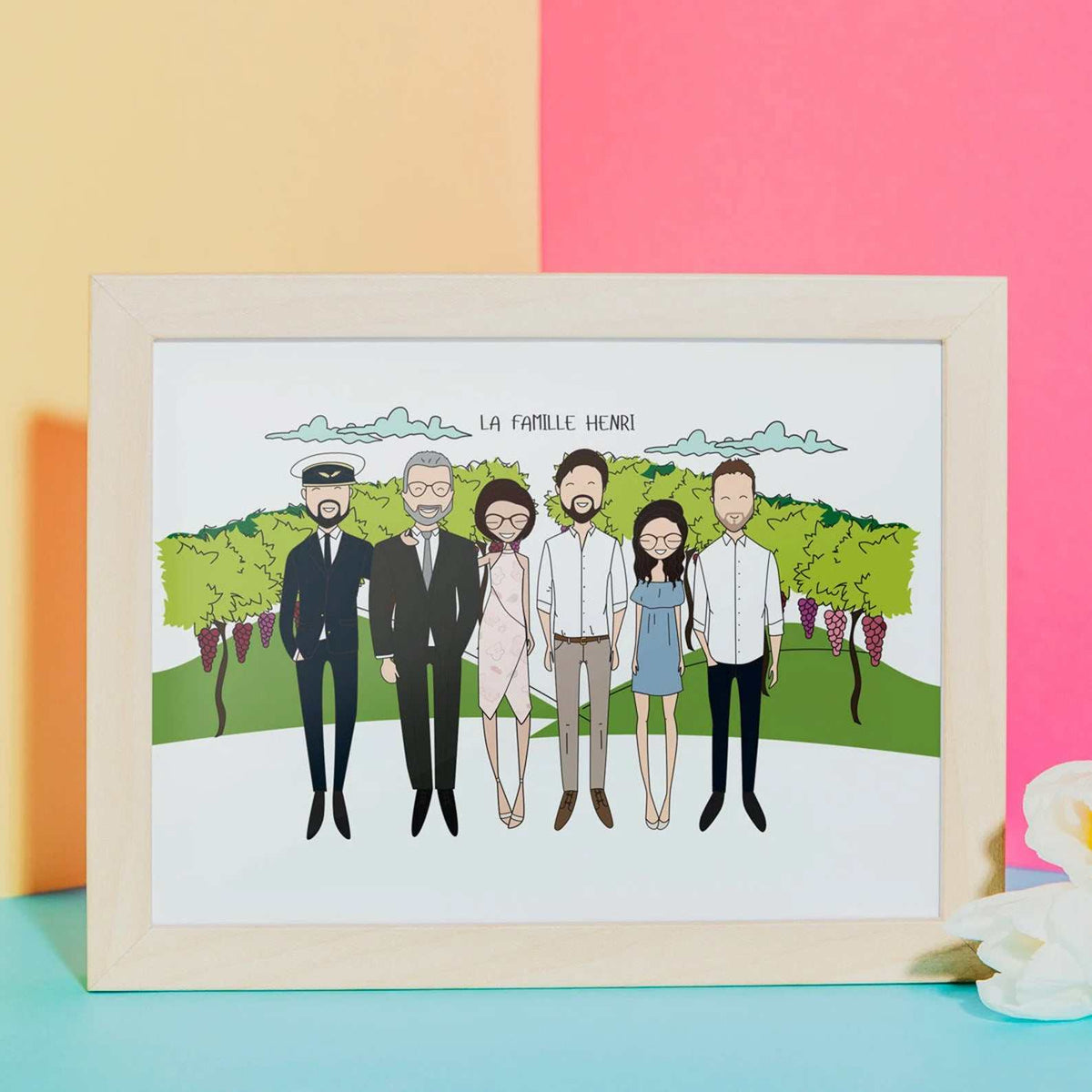 Personalized family portrait with custom background of a lush vineyard setting, framed as a custom retirement gift or family reunion keepsake. The text "La Famille Henri" is written at the top of the illustration.