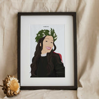 Framed personalized hand-painted portrait illustration of a smiling woman with dark hair wearing a laurel wreath and graduation gown, serving as a unique personalized graduation gift.