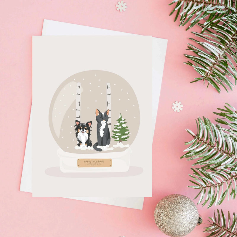 Handmade custom illustration of a long-haired Chihuahua and cat inside a snow globe on a Personalized Pet Portrait for Christmas Card holiday greeting.