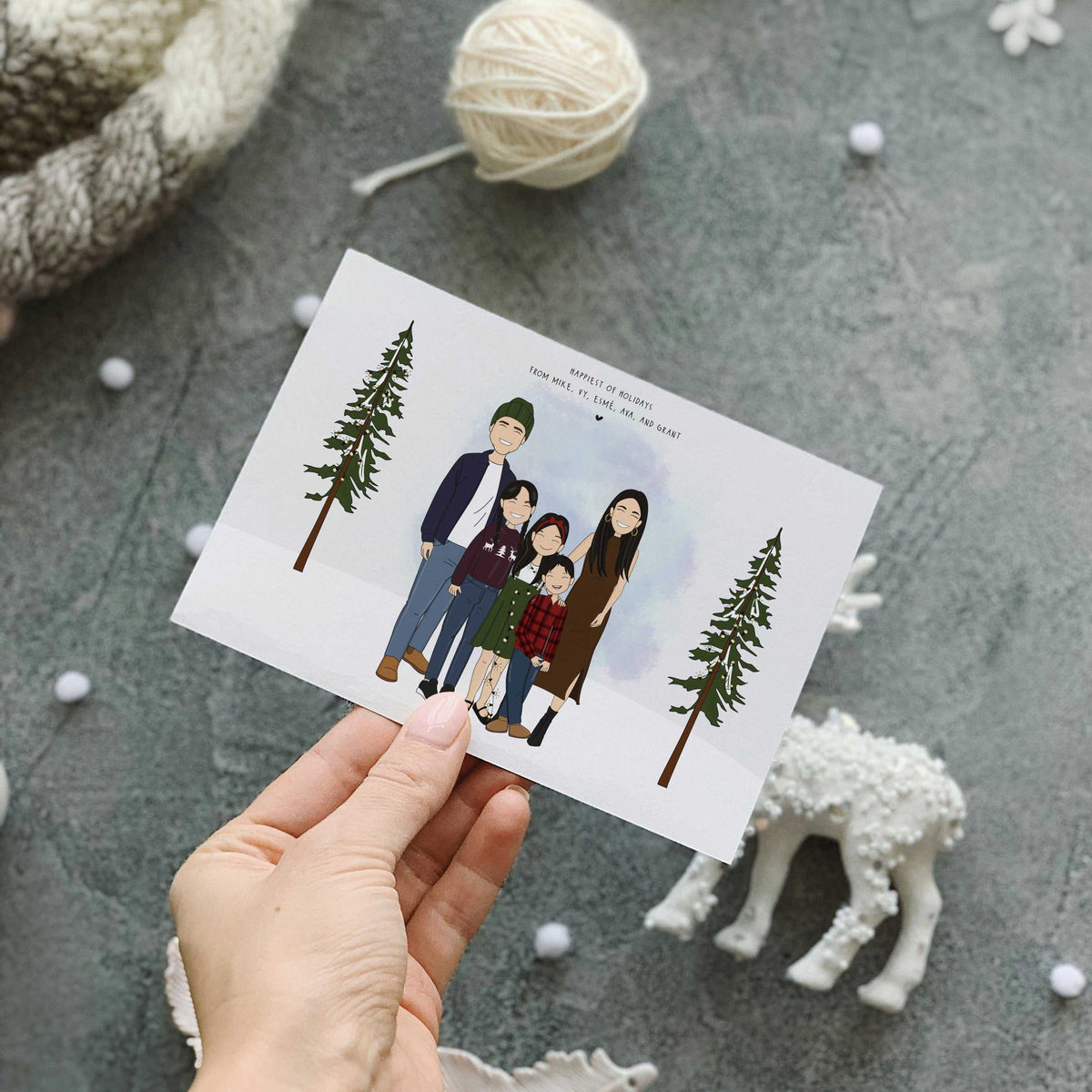 A personalized family portrait for Christmas cards printed as a custom holiday card, depicting a detailed hand-drawn illustration of a family of five, including children and a baby, celebrating together in a snowy landscape. A personalized Holiday Greeting Card.