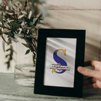 A hand-drawn Mother’s Day card featuring a large blue floral initial "S" decorated with pink blossom and green leaves. A white banner across the letter displays the name "Stephanie" in elegant script. At the bottom, a heartfelt Mother's Day quote. This personalized A5 thank you gift has a clean, artistic feel, perfect for a sentimental keepsake.