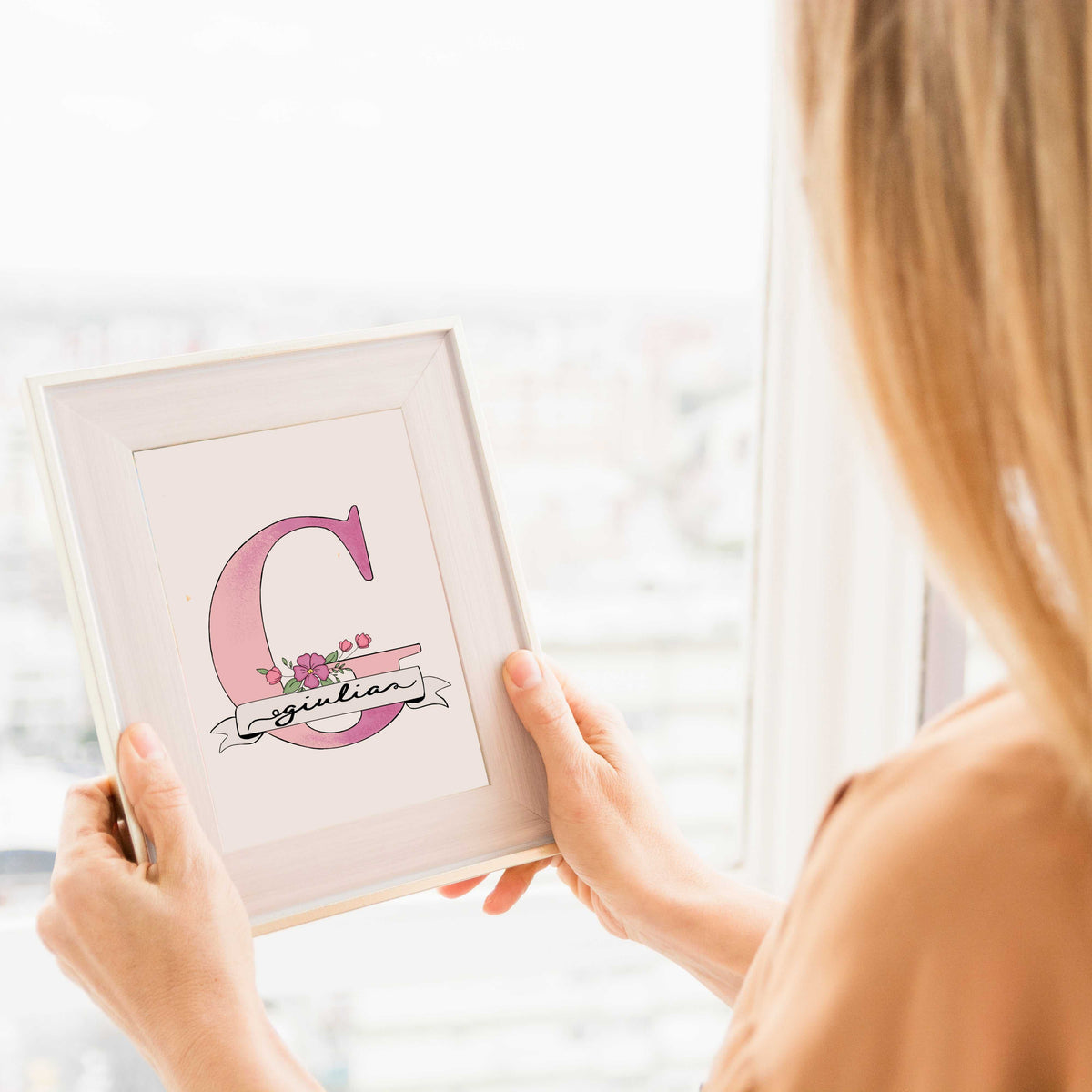 A hand-drawn Mother’s Day card featuring a large pink floral initial "G" decorated with pink blossom and green leaves. A white banner across the letter displays the name "Giulia" in elegant script. At the bottom, a heartfelt Mother's Day quote. This personalized A5 thank you gift has a clean, artistic feel, perfect for a sentimental keepsake.