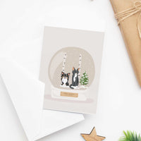 Handmade custom illustration of a long-haired Chihuahua and cat inside a snow globe on a Personalized Pet Portrait for Christmas Card holiday greeting.