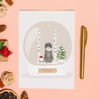 A custom greeting card featuring a Personalized Pet Portrait for Christmas Card. The central hand-drawn illustration displays a tabby cat inside a detailed winter snow globe with birch trees, a Christmas tree, and a small gnome. The snow globe base includes a personalized message that reads "HAPPY HOLIDAYS! JEN AND PEBBLES."