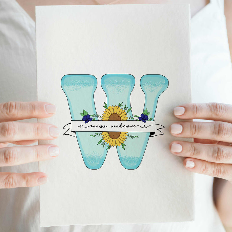 Custom hand-drawn floral letter "W" for Miss Wilcox. A unique, personalized teacher gift from students featuring a name banner and realistic flowers. The perfect last-minute, budget-friendly thank you gift that teachers actually want.