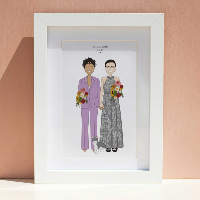 Framed custom wedding illustration portrait of a same-sex couple, one in a lavender suit and one in a grey floral dress, holding hands with their cat, displayed in a white frame against a peach wall.